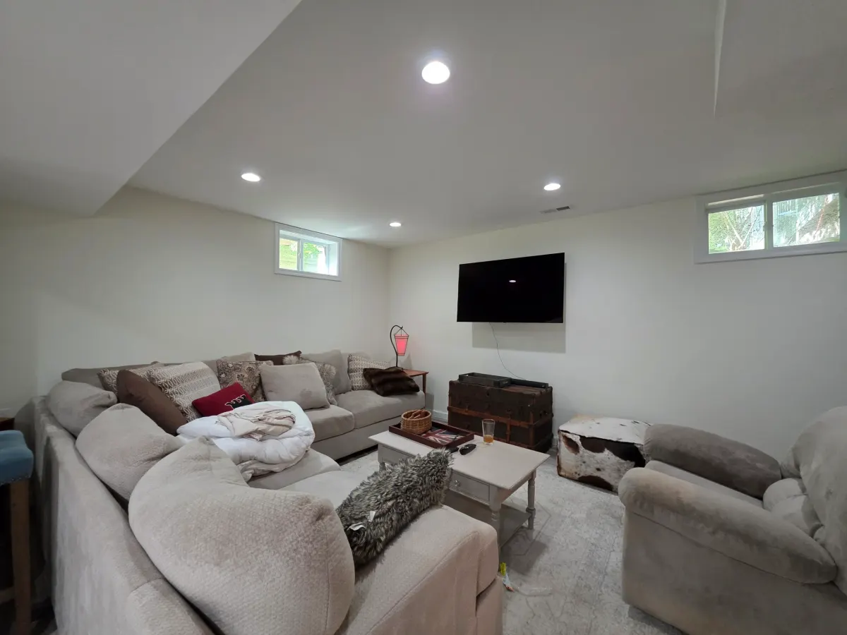 Spacious room with dark hardwood flooring, white baseboards, and natural light creating an elegant atmosphere.
