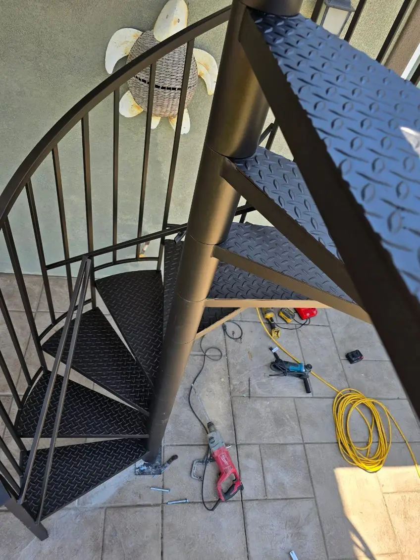 Custom wrought iron gate installation in Los Angeles with elegant design and lush landscaping.