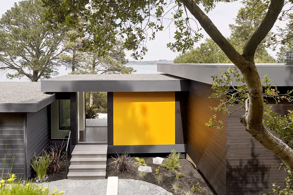 Charming suburban house in Folsom CA with vibrant blue exterior paint and lush landscaping under a clear sky.