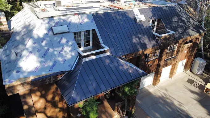 Exterior of a Modesto California clay tile cleaning business with a shiny cleaned roof, building facade, signage, and landscaped surroundings