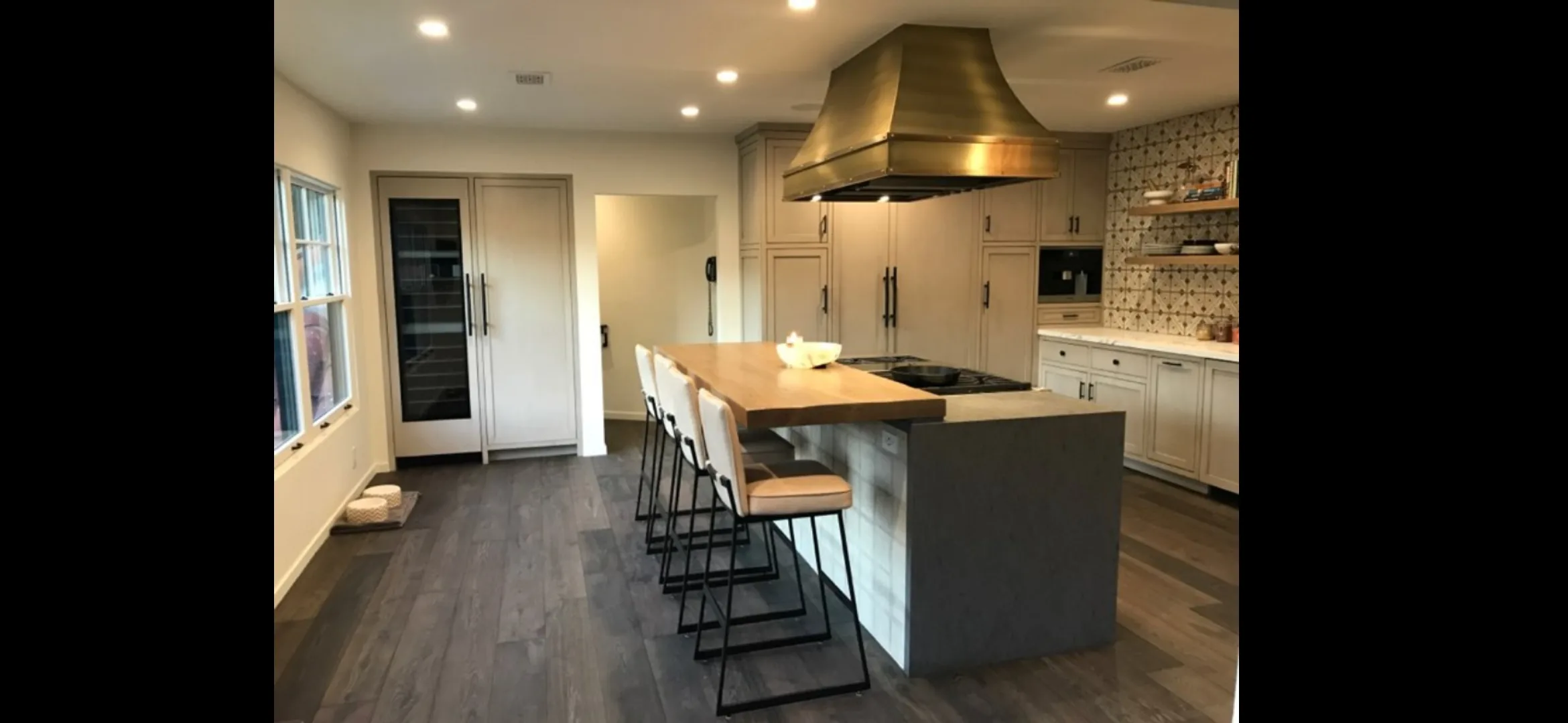 Remodeled kitchen in Port St. Lucie with modern cabinetry, quartz counters, stainless appliances, and natural lighting.