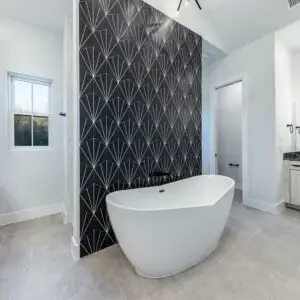 Modern custom tile shower in Austin with mosaic and large tiles, glass doors, sleek fixtures, and natural light
