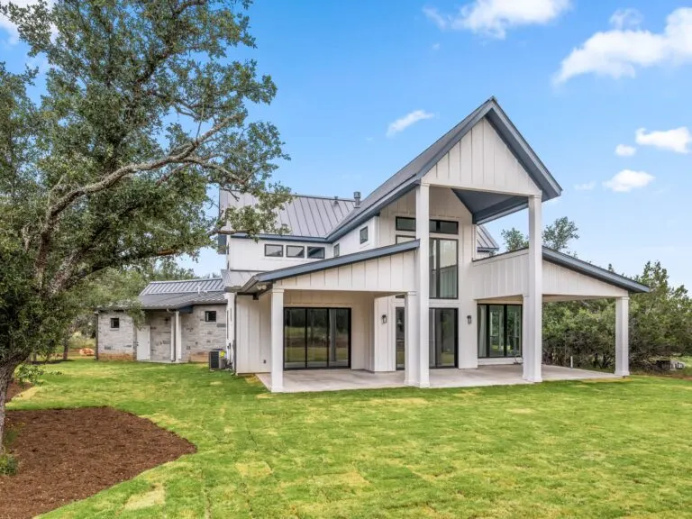 Newly remodeled Austin kitchen with modern cabinetry, granite island, stainless steel appliances, and large windows.