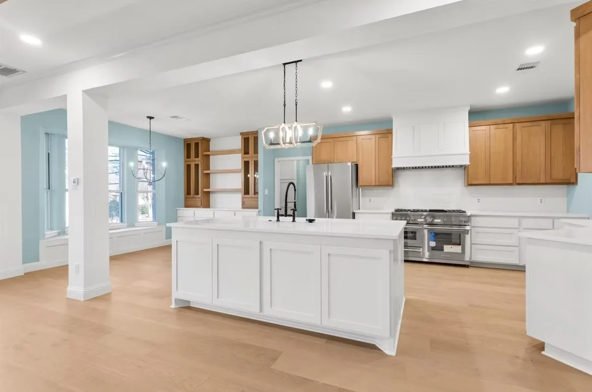 Modern Austin kitchen with polished quartz countertop, sleek cabinetry, natural light, urban view, and modern appliances