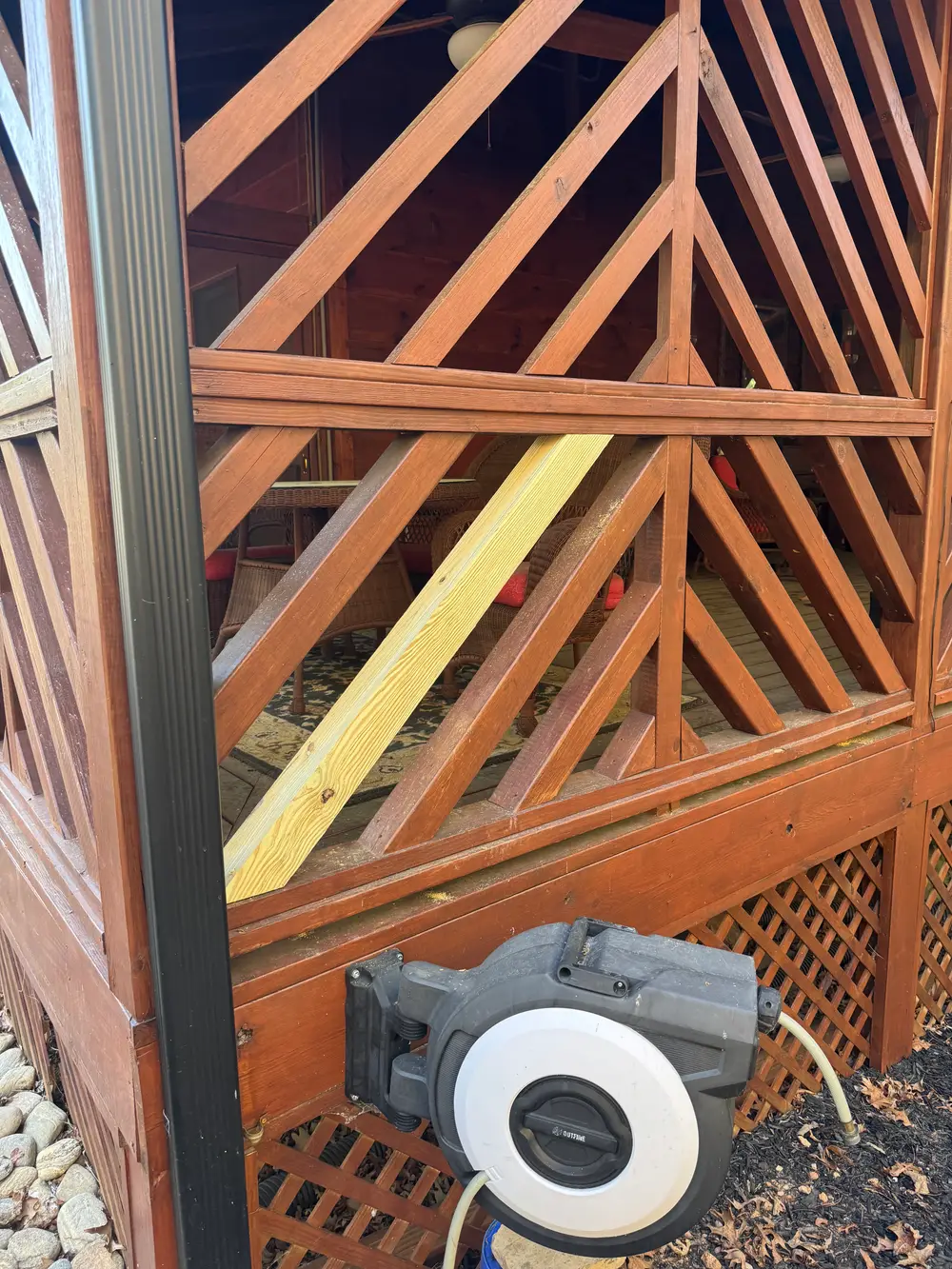 Wooden gate repair in Cohutta GA showcasing craftsmanship with lush greenery and a serene suburban atmosphere.