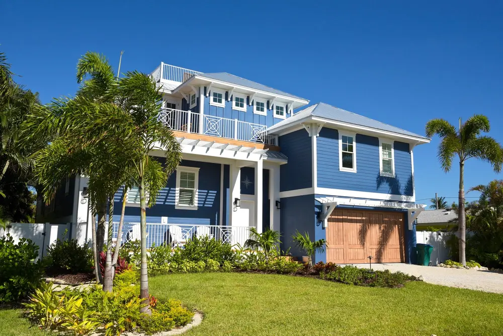 Completed elastomeric and waterproof coatings project in New Smyrna Beach FL showcasing a glossy finish on a residential building.