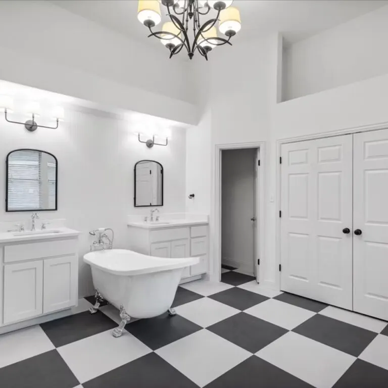 Beautiful custom tile shower in Austin with warm mosaic tiles, sleek fixtures, glass enclosure, and natural light.