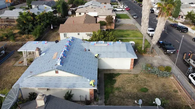 Freshly repaired skylight flashing on a clean, well-maintained residential roof in Modesto California under sunny skies