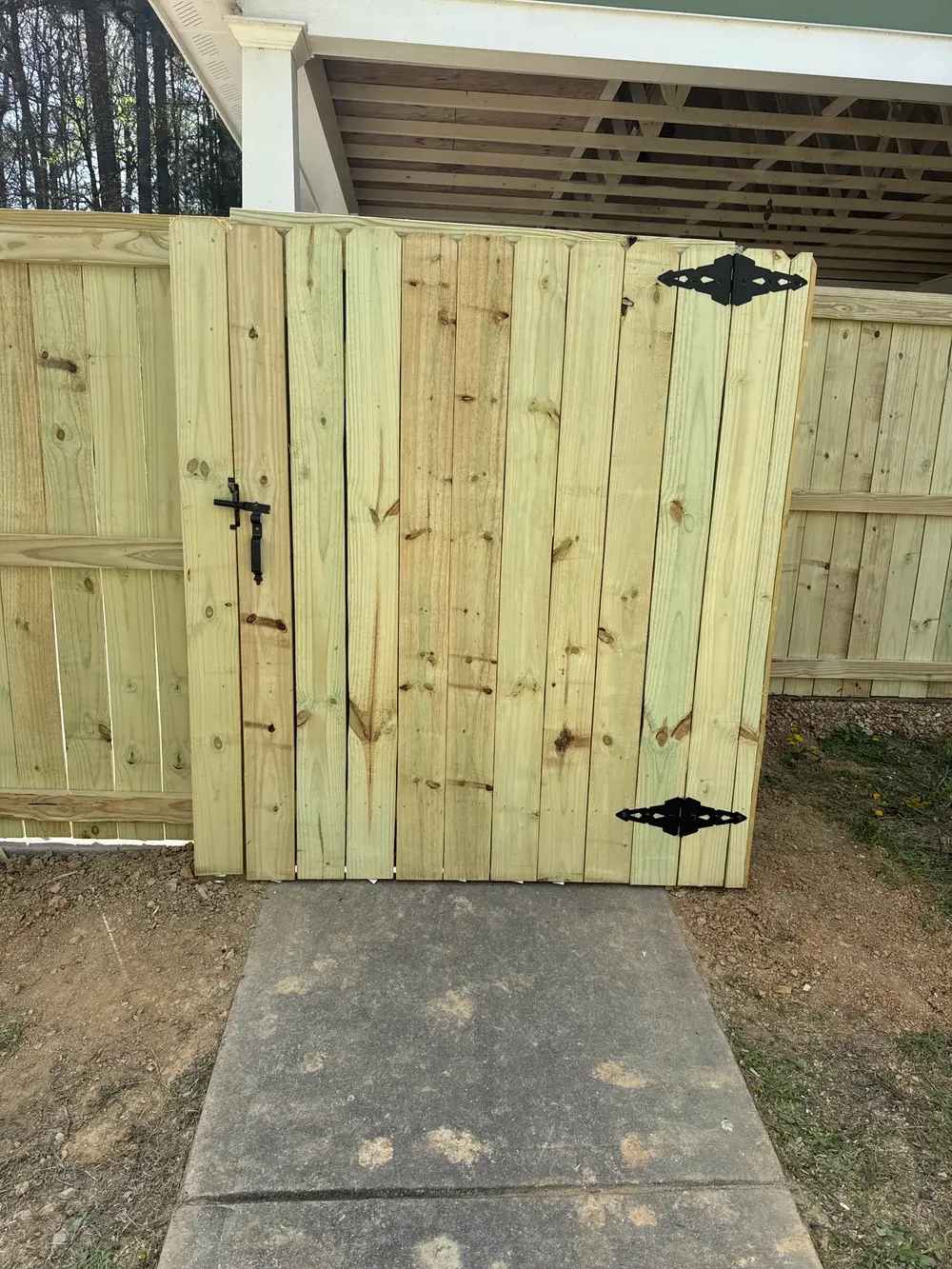 Completed Walk Gate Installation in Cohutta GA featuring elegant metalwork, wooden finish, and lush landscaping.