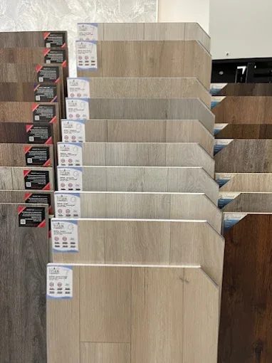 Hardwood floor squeak repair in Naples FL showcasing seamless transition and polished planks in a stylish room.