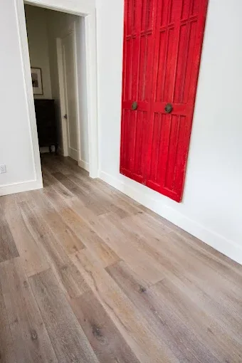 Completed hardwood flooring installation in Bonita Beach FL with warm tones and elegant decor in a sunlit room.