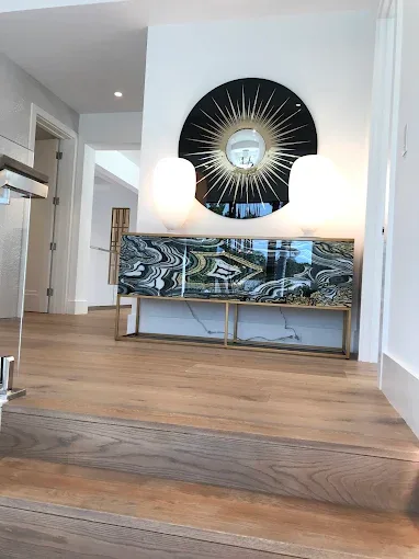 Polished hardwood floor in Naples, FL, featuring warm tones and elegant furniture in a bright, inviting space.