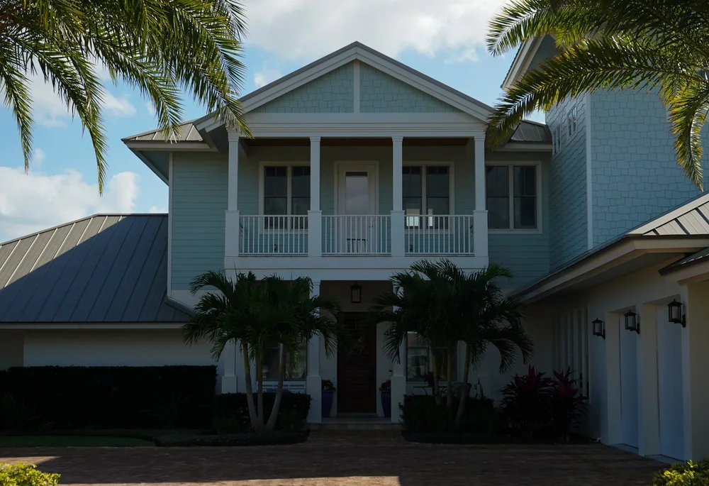 Completed Elastomeric and Waterproof Coatings project in New Smyrna Beach with glossy finish and tropical landscaping.