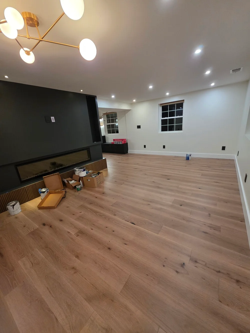 Modern living space in Lansdowne VA featuring elegant hardwood flooring, stylish decor, and natural light.