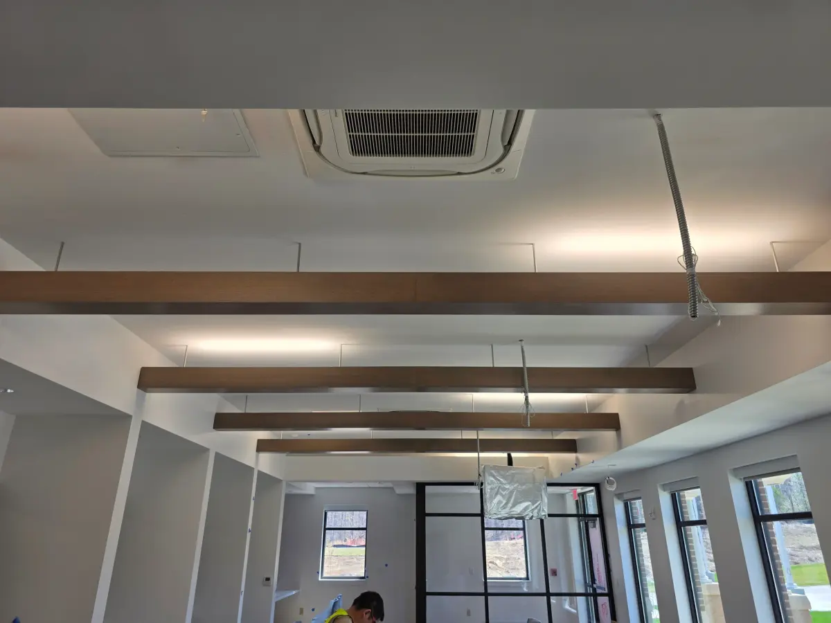 Completed reducer strip installation in Centreville VA showing seamless transition between hardwood and tile flooring.