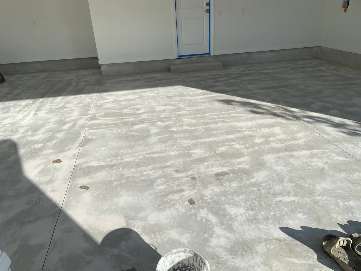 Polyaspartic floor coating in modern Jacksonville garage with glossy finish, vibrant colors, and organized tools.