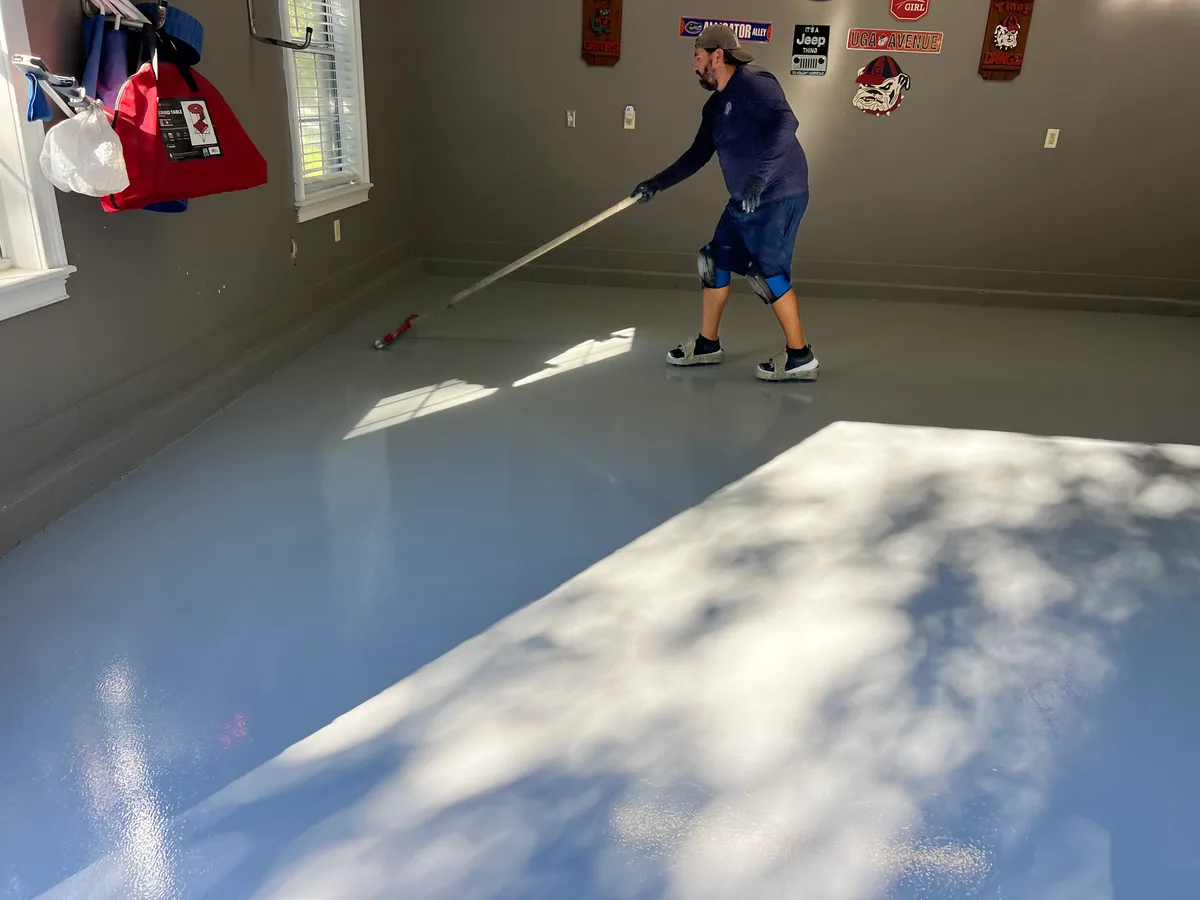 Modern commercial space in Jacksonville with glossy blue and silver epoxy flooring and natural light from large windows