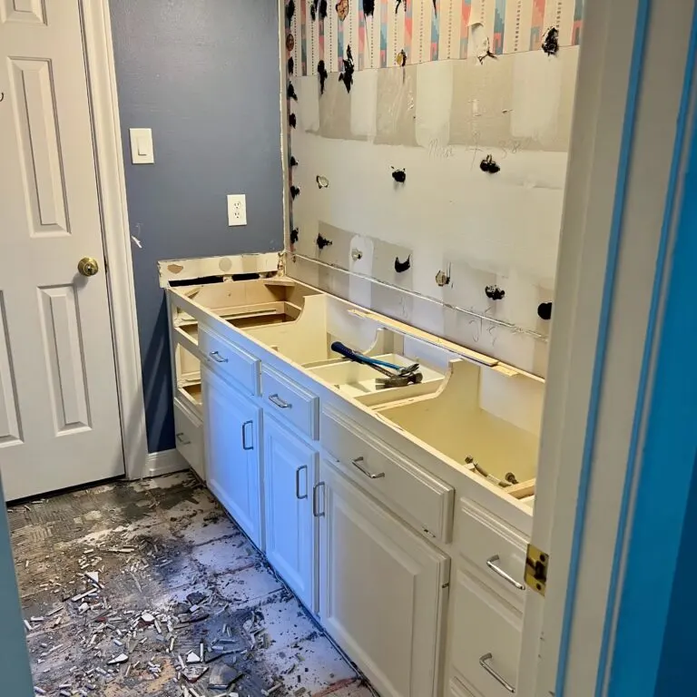 Modern kitchen remodel in Manchaca TX featuring sleek appliances, elegant granite, and custom cabinetry with warm lighting.