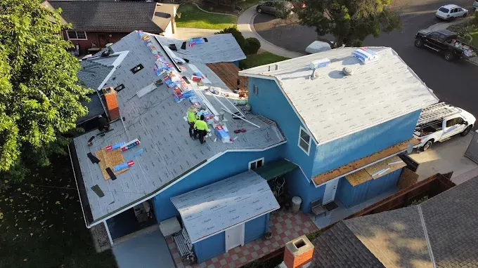 Freshly installed roof vent on asphalt shingle roof in Modesto CA with suburban neighborhood background and bright daylight
