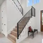 Recently removed load bearing wall in Austin TX showcases a spacious open-concept modern interior with polished hardwood floors and natural light