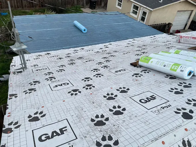 Detailed image of a completed roof flashing repair on a residential Modesto roof, showing seamless metal flashing and textured shingles under bright midday light