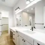 Modern kitchen remodel in Rough Hollow TX with sleek cabinetry, quartz island, and stainless appliances, enriched by natural light.