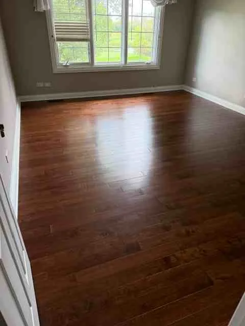 Finished concrete floor leveling project in Darien IL with polished surface, modern baseboards, and organized workspace.