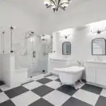 Modern high-end Austin bathroom with a sleek walk-in shower featuring frameless glass doors, rainfall showerhead, and neutral-toned porcelain tiles