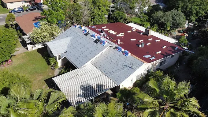 Freshly replaced roof on a modern Modesto home with rich shingles, manicured yard, and clear blue sky.