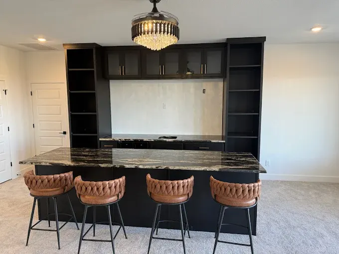 Completed kitchen remodel in Austin with modern cabinetry, quartz island, stainless steel appliances, and natural light.