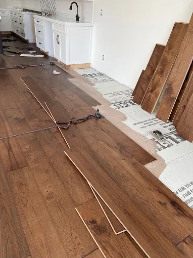 Dustless hardwood floor refinishing in Naples FL features polished wood under natural light in an elegant room.