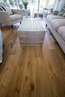 Wood flooring installation in Cape Coral, FL, showcasing rich tones, spacious room, natural light, and elegant decor.