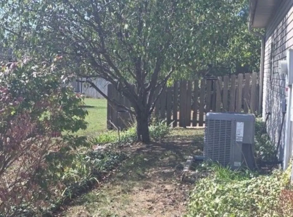 Privacy fence installation project in Columbia MO showcasing wooden panels and a finished yard.
