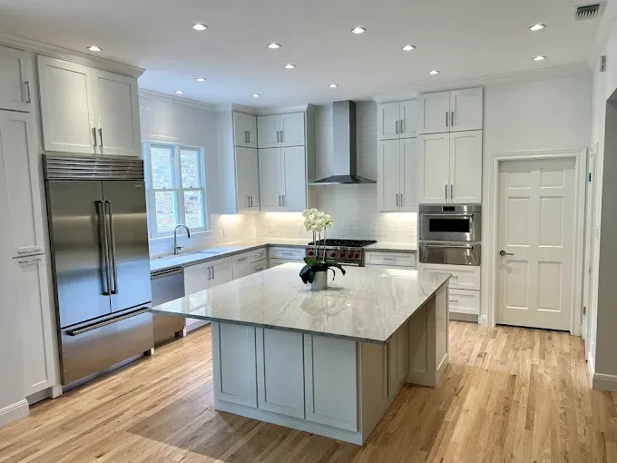 Remodeled Austin kitchen with granite countertops, stainless appliances, custom wood cabinets, subway tile backsplash, marble island, hardwood floors, and city views