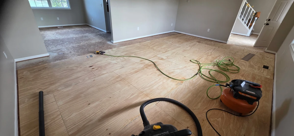 Smooth wooden subfloor repair in a modern Darien IL basement, showcasing expert craftsmanship and inviting atmosphere.