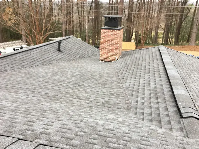 Freshly completed residential roof installation in Trussville AL, showcasing detailed shingles and a suburban neighborhood.
