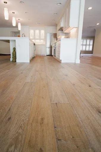 Wood flooring installation in a modern coastal home with polished oak planks, stylish furniture, and natural light.