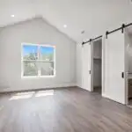 New modern Austin home addition with sleek design, large energy-efficient windows, native landscaping, and lush neighborhood.