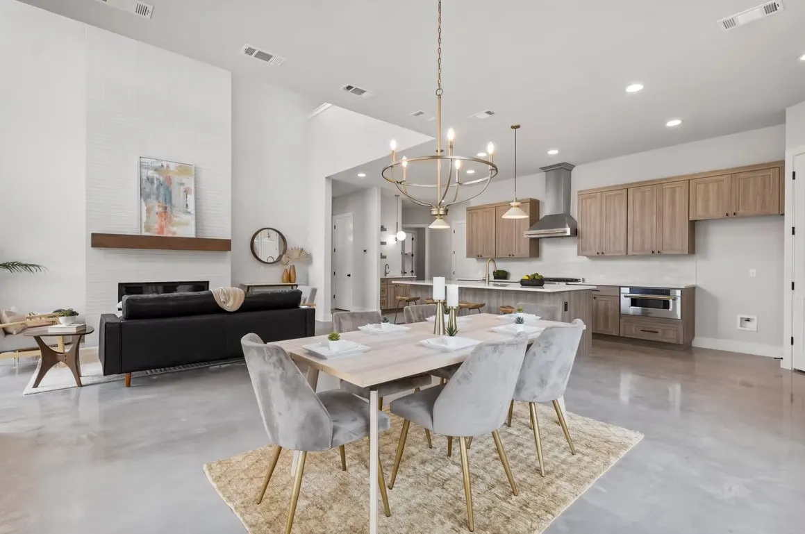Luxurious remodeled Austin kitchen with granite countertops, custom cabinets, stainless steel appliances, hardwood floors, and natural sunlight