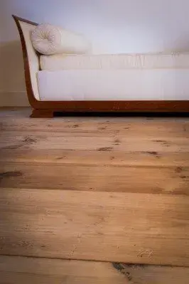Completed wood flooring installation in a modern Estero FL living room with warm tones and elegant decor.