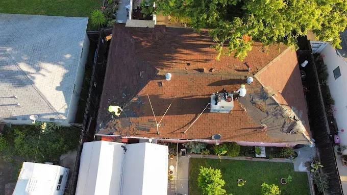 Freshly completed roof replacement on a suburban home in Modesto, CA, showcasing quality shingle roofing and landscaping.