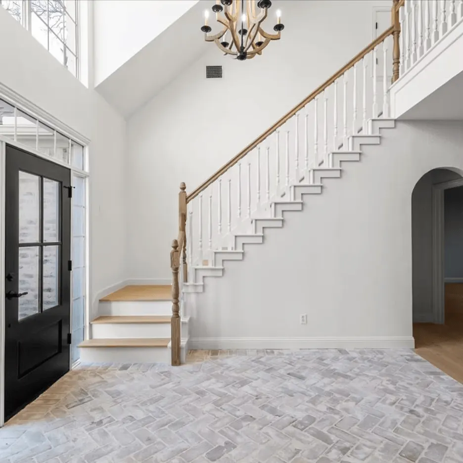 Modern kitchen and living area in Rollingwood TX, showcasing sleek cabinets, granite countertops, and spacious patio.