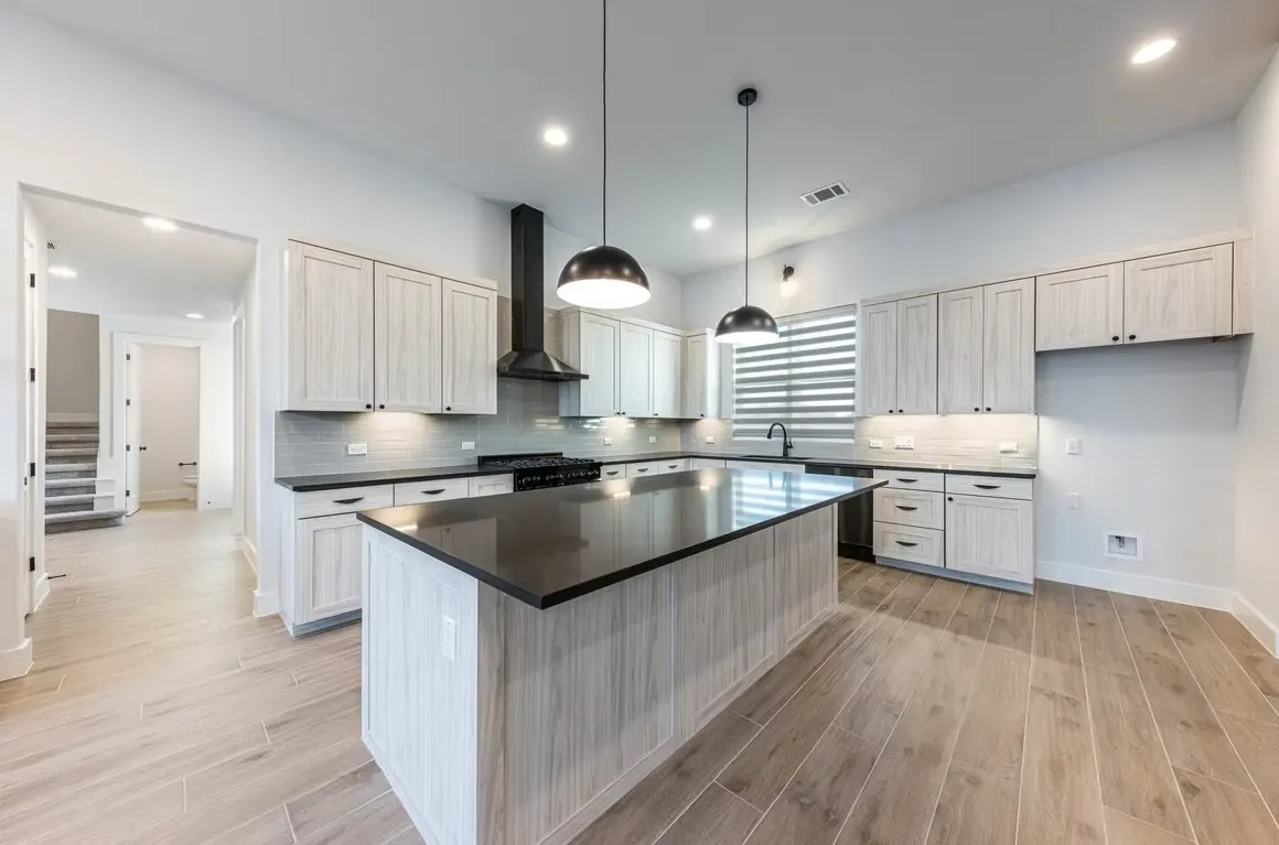 Elegant remodeled living space in Holly TX features modern kitchen, stylish decor, and cozy reading nook.