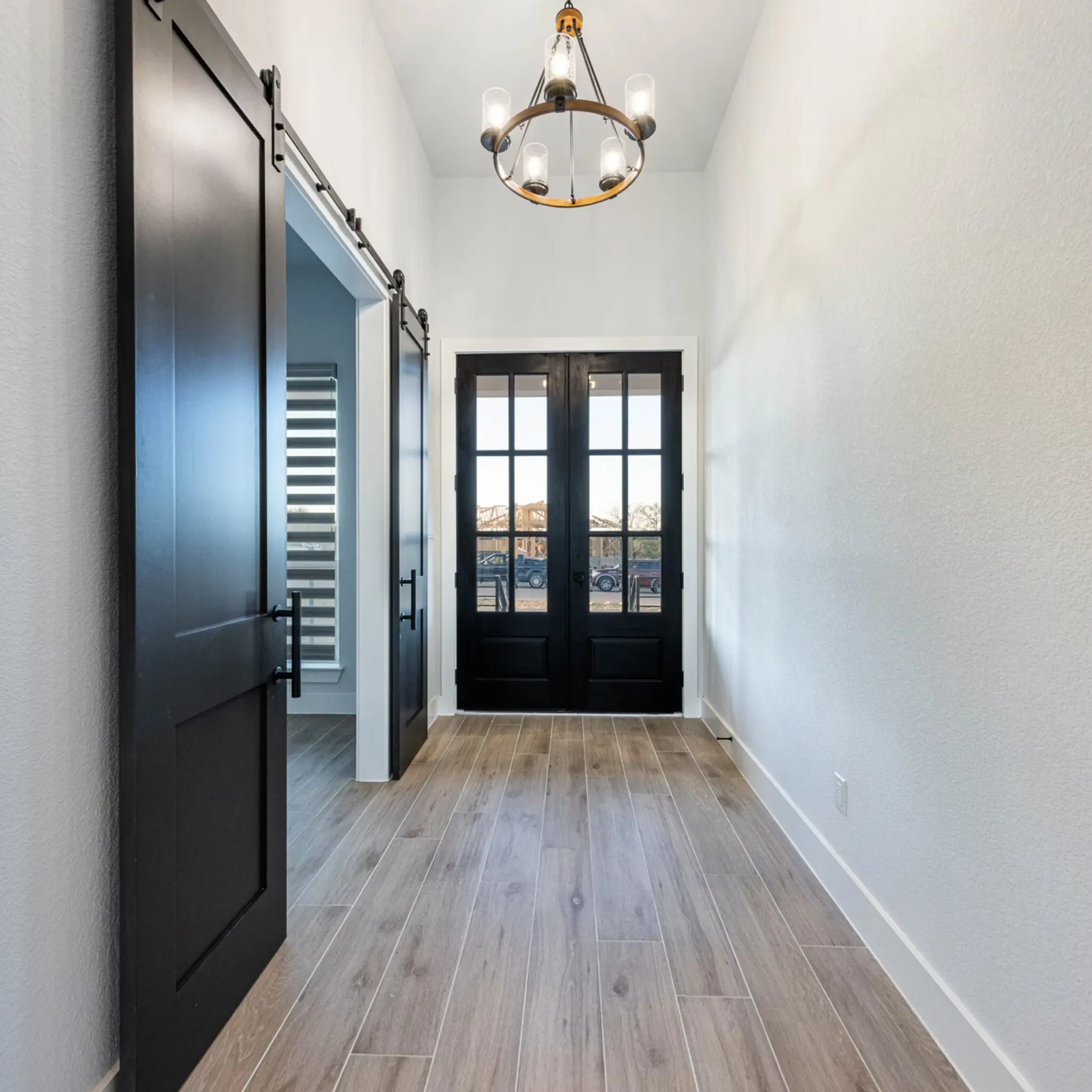 Home remodeling project in Mueller TX featuring elegant design, lovely landscaping, welcoming porch, and modern interior.
