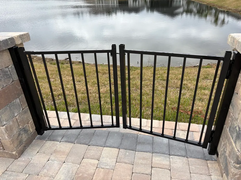 Automatic gate installation in St. Augustine FL showcasing a polished design, elegant pillars, and landscaped driveway.