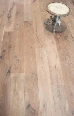 Wood flooring installation in a modern Fort Myers home with dark walnut planks and elegant minimalistic decor.