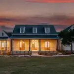 Modern remodeled kitchen in Holly TX with white cabinets granite island stainless appliances hardwood floors and natural light