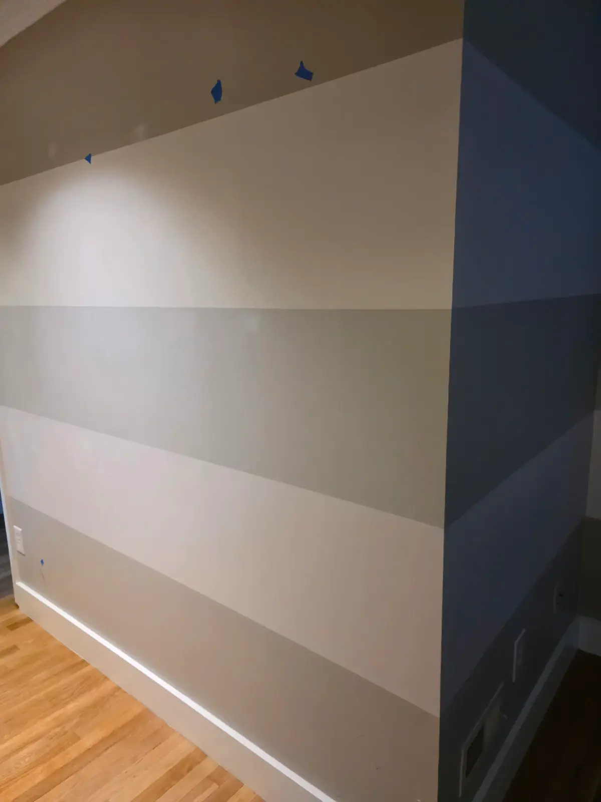Reducer strip installation in Centreville VA with dark hardwood and light laminate flooring in a modern living space.