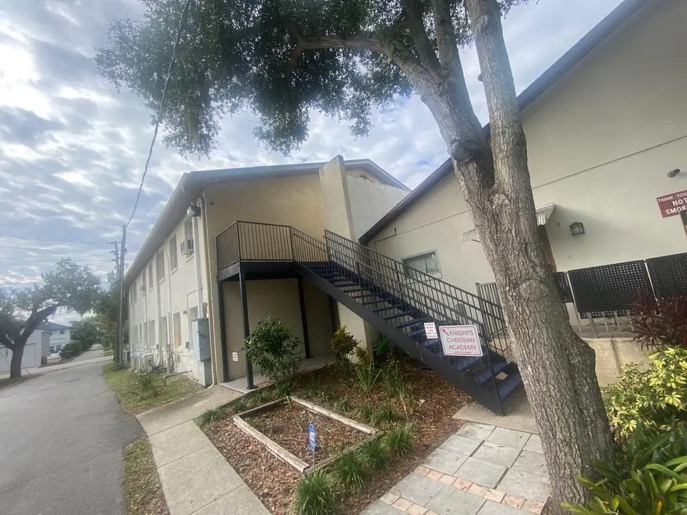 Pristine New Smyrna Beach home after pressure washing, showcasing clean siding, sparkling windows, and lush landscaping.