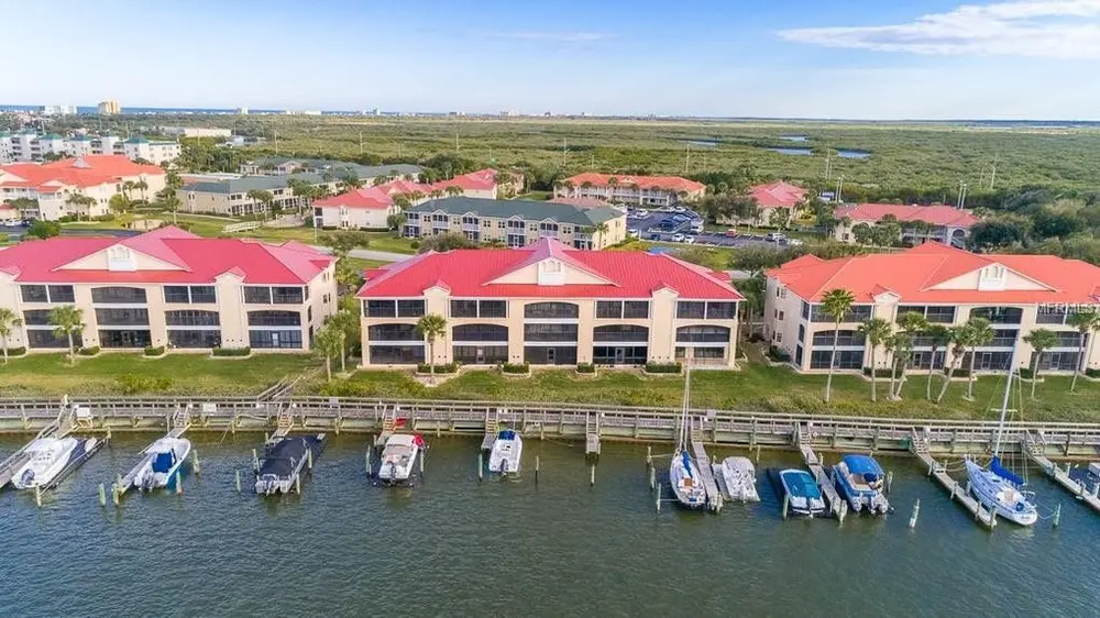 Serene coastal landscape of Ponce Inlet FL with gentle waves, vibrant marine life, and a sunset over the beach.